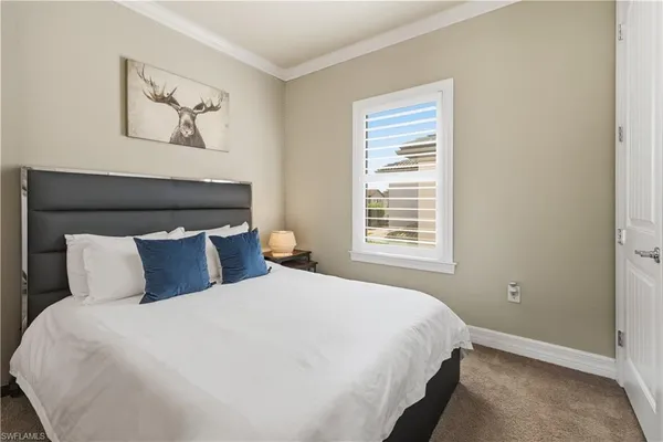 a bedroom with a large bed and a window