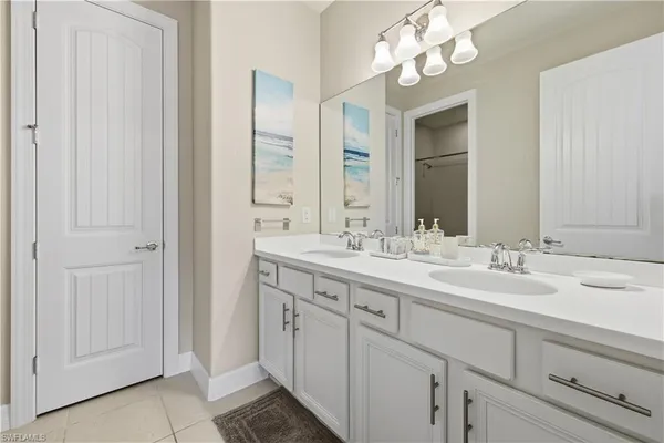 a bathroom with a double vanity sink and a mirror