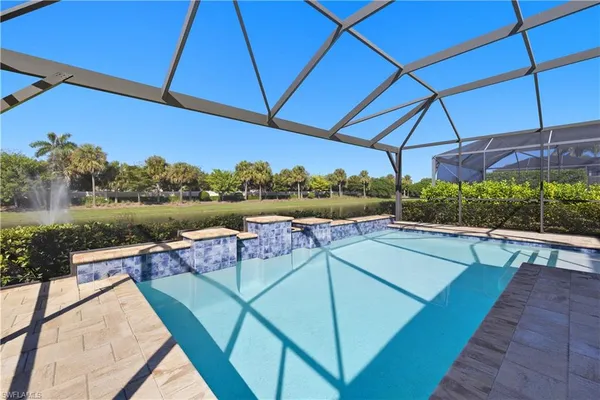 a view of a chairs and table under an umbrella