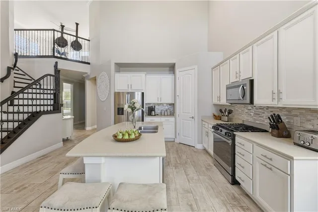 a kitchen with cabinets a sink and appliances