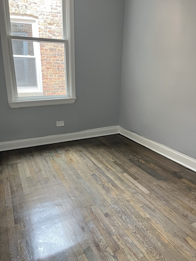 3821 West Fillmore Street, Unit 1R Chicago, IL 60624 - Photo 14 of 14 an empty room with a window