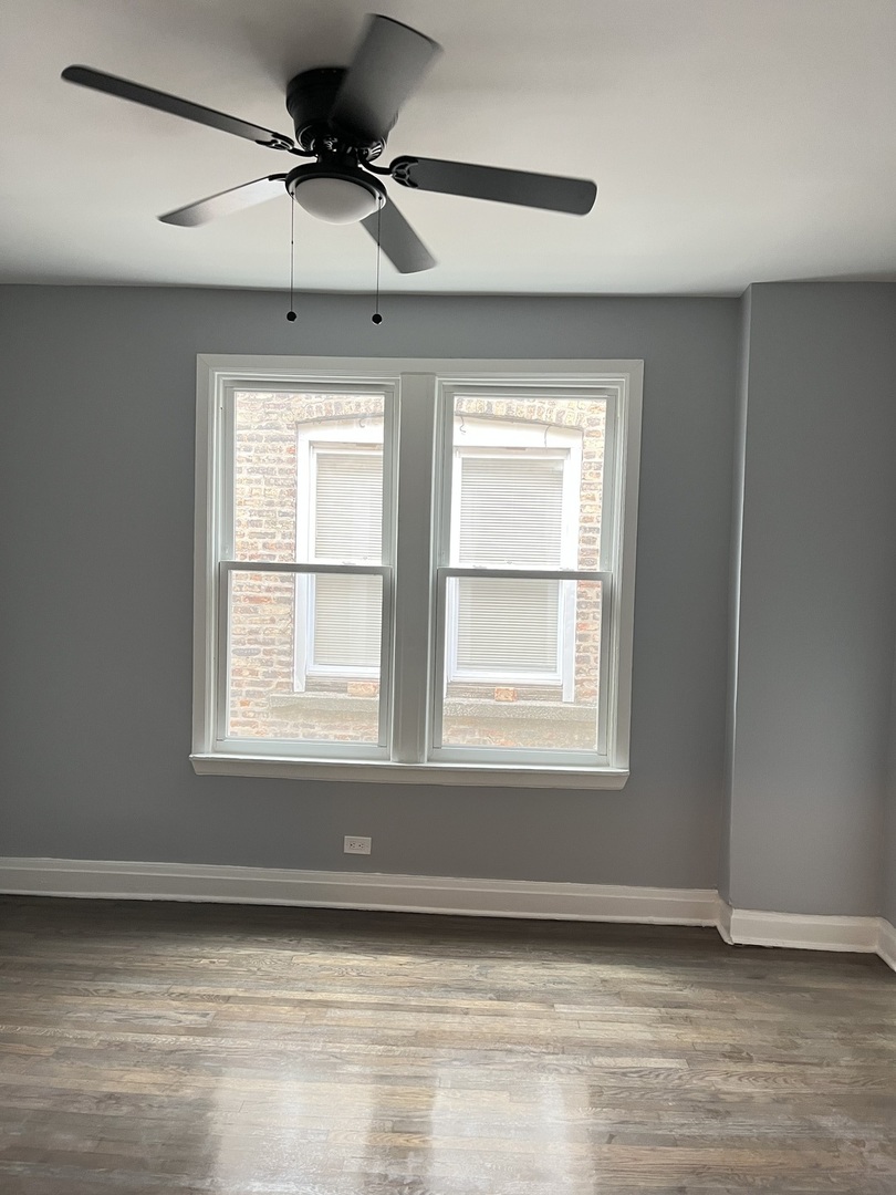 3821 West Fillmore Street, Unit 1R Chicago, IL 60624 - Photo 6 of 14 a view of an empty room with a window