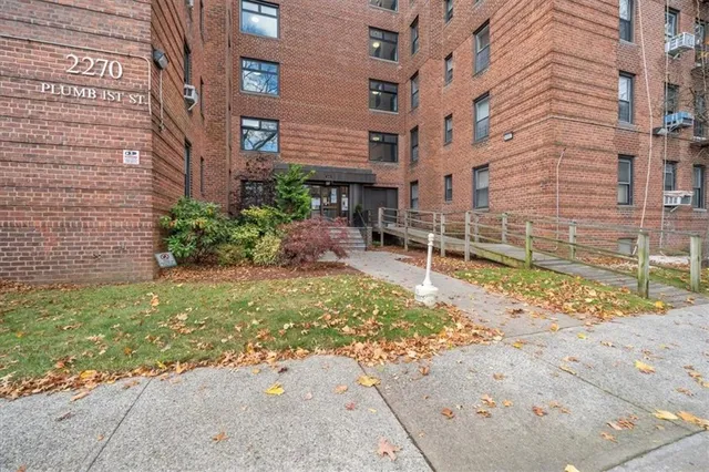 a view of a brick building with many windows
