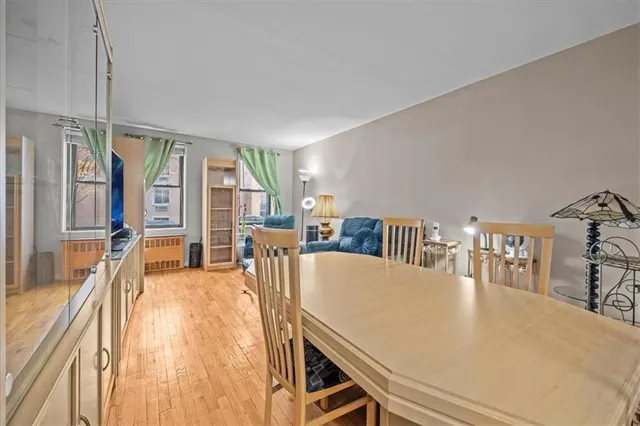 a living room with furniture a large window and a wooden floor