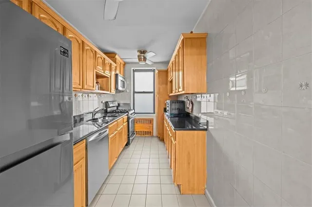 a kitchen with stainless steel appliances granite countertop a sink and a stove