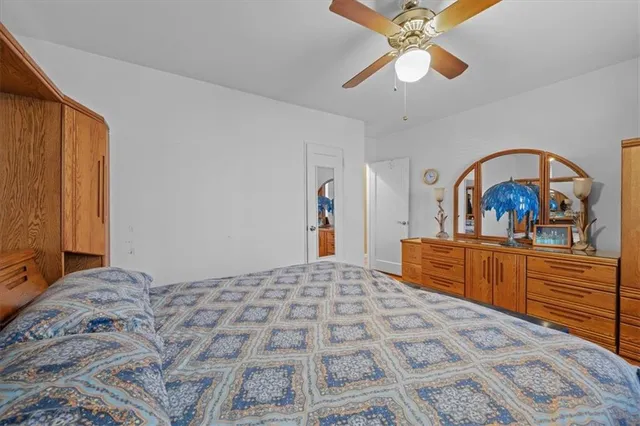 a bedroom with a large bed and a chandelier