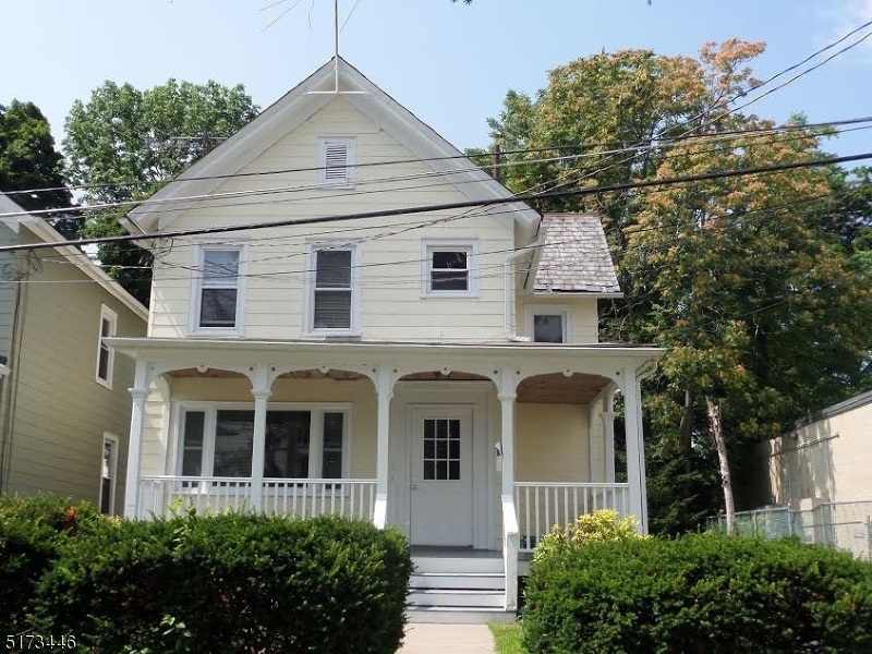 18 Washington Street, Unit 2 Newton, NJ 07860 - Photo 1 of 2 a view of a white house with large windows and a small yard