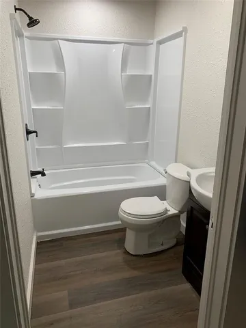 a bathroom with a toilet and a shower