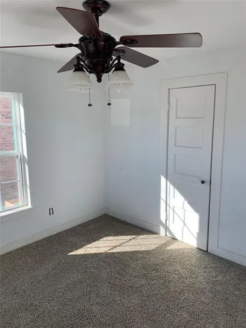 a view of a room with a window and a fan