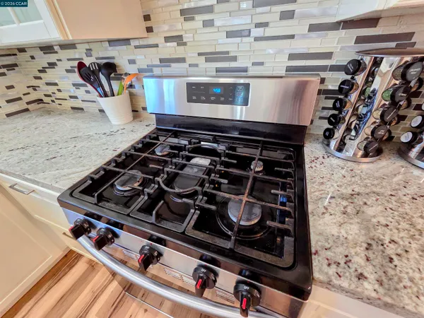 a view of a backyard with wooden fence and large trees