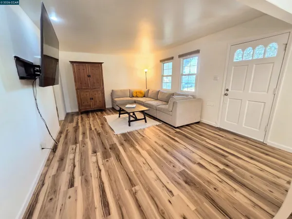 a dining room with wooden floor and breakfast area