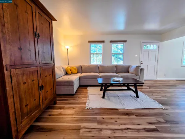 a view of a dining room with furniture wooden floor and chandelier