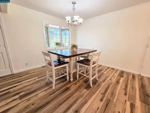 a kitchen with stainless steel appliances granite countertop a kitchen island hardwood floor and a sink