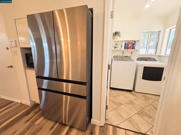 a bathroom with a granite countertop toilet and a sink