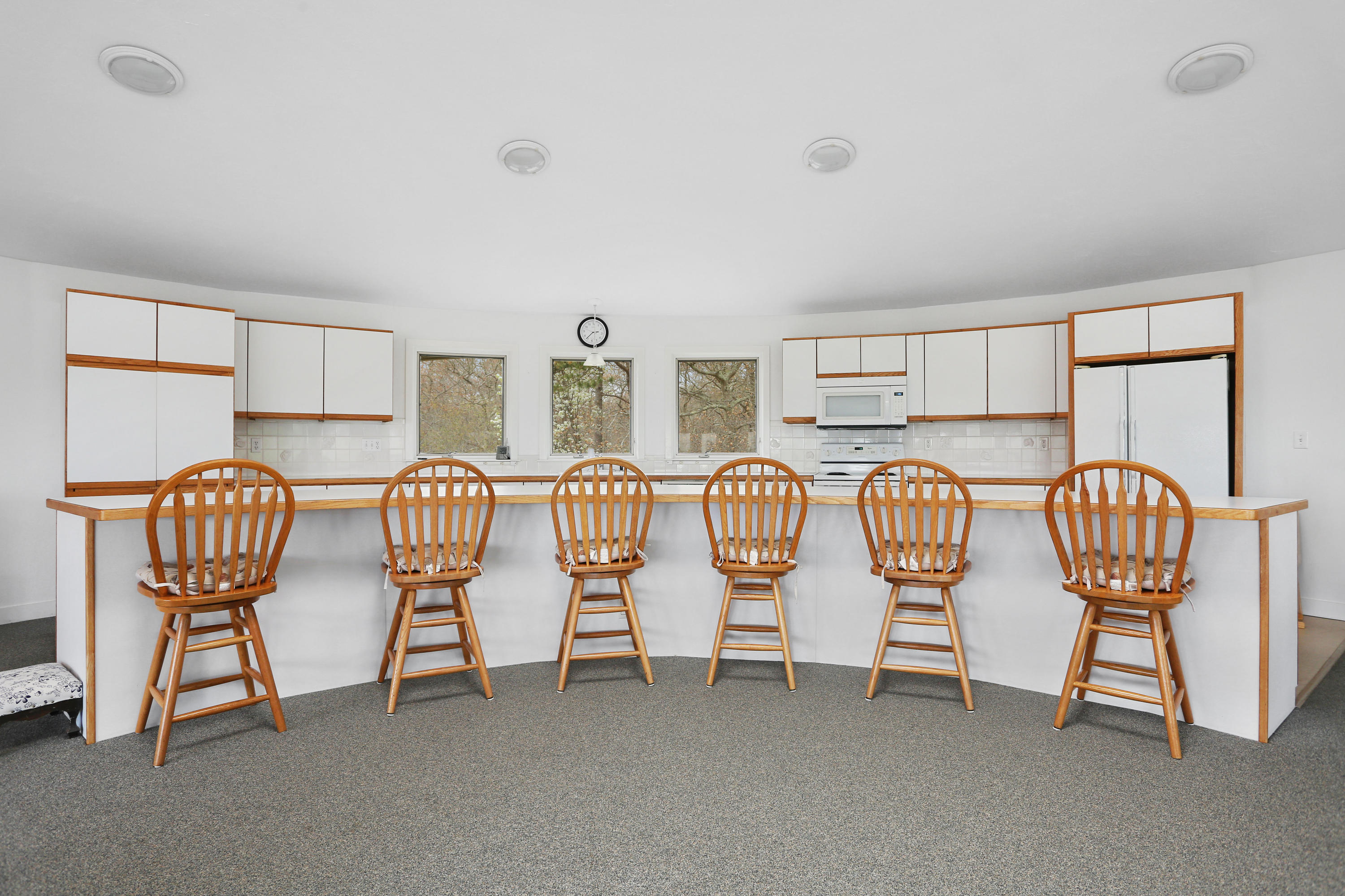 38 Weather Deck Road Bourne, MA 02532 - Photo 21 of 40 a group of chairs sitting in a room with two window