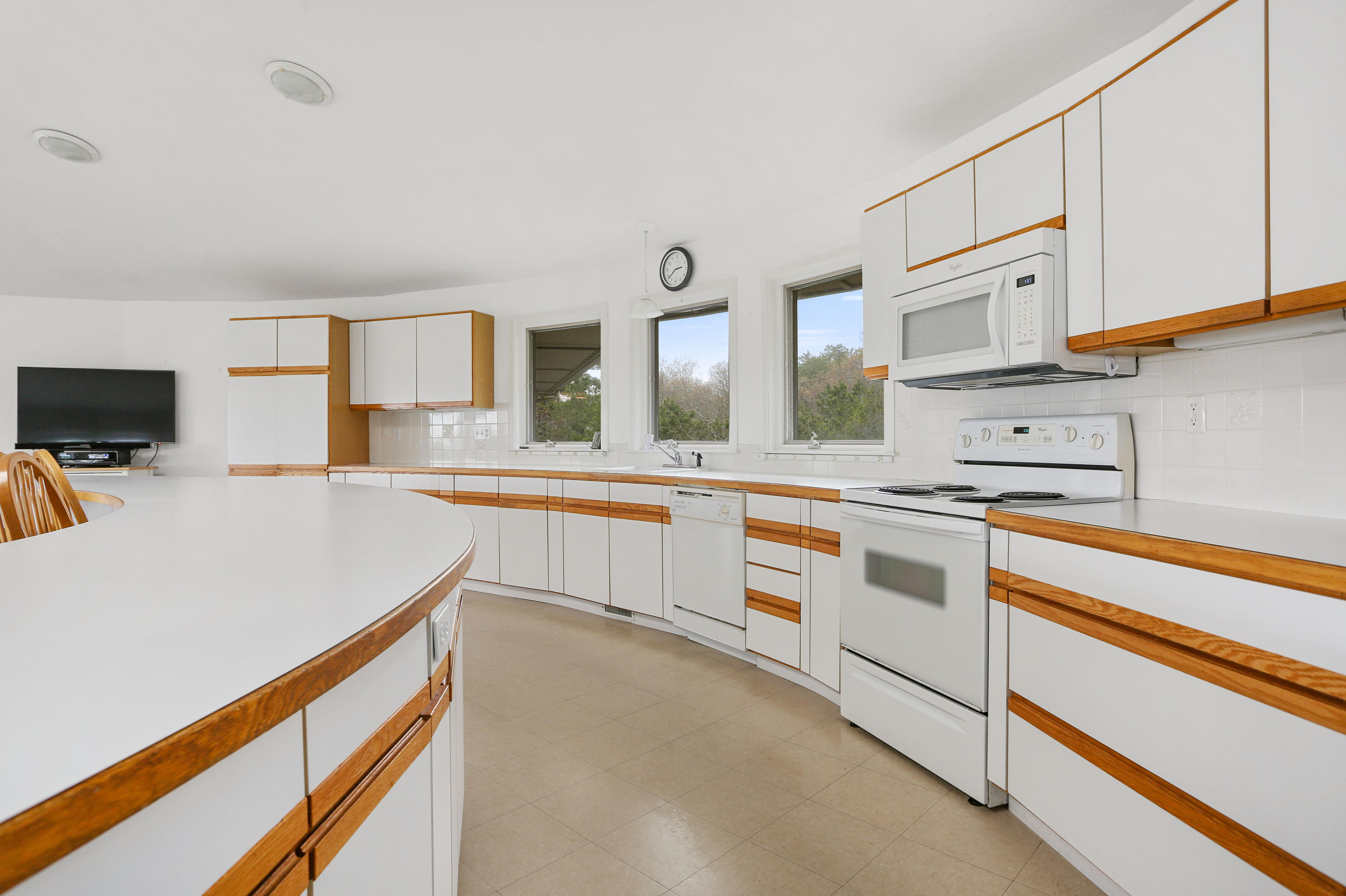 38 Weather Deck Road Bourne, MA 02532 - Photo 23 of 40 a kitchen with granite countertop white cabinets and white appliances