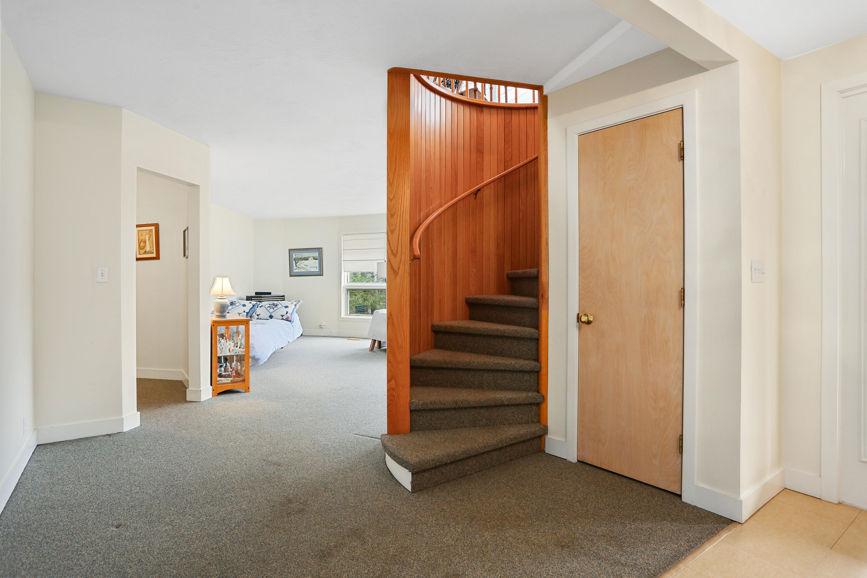 38 Weather Deck Road Bourne, MA 02532 - Photo 5 of 40 a view of a hallway with staircase and a cabinet