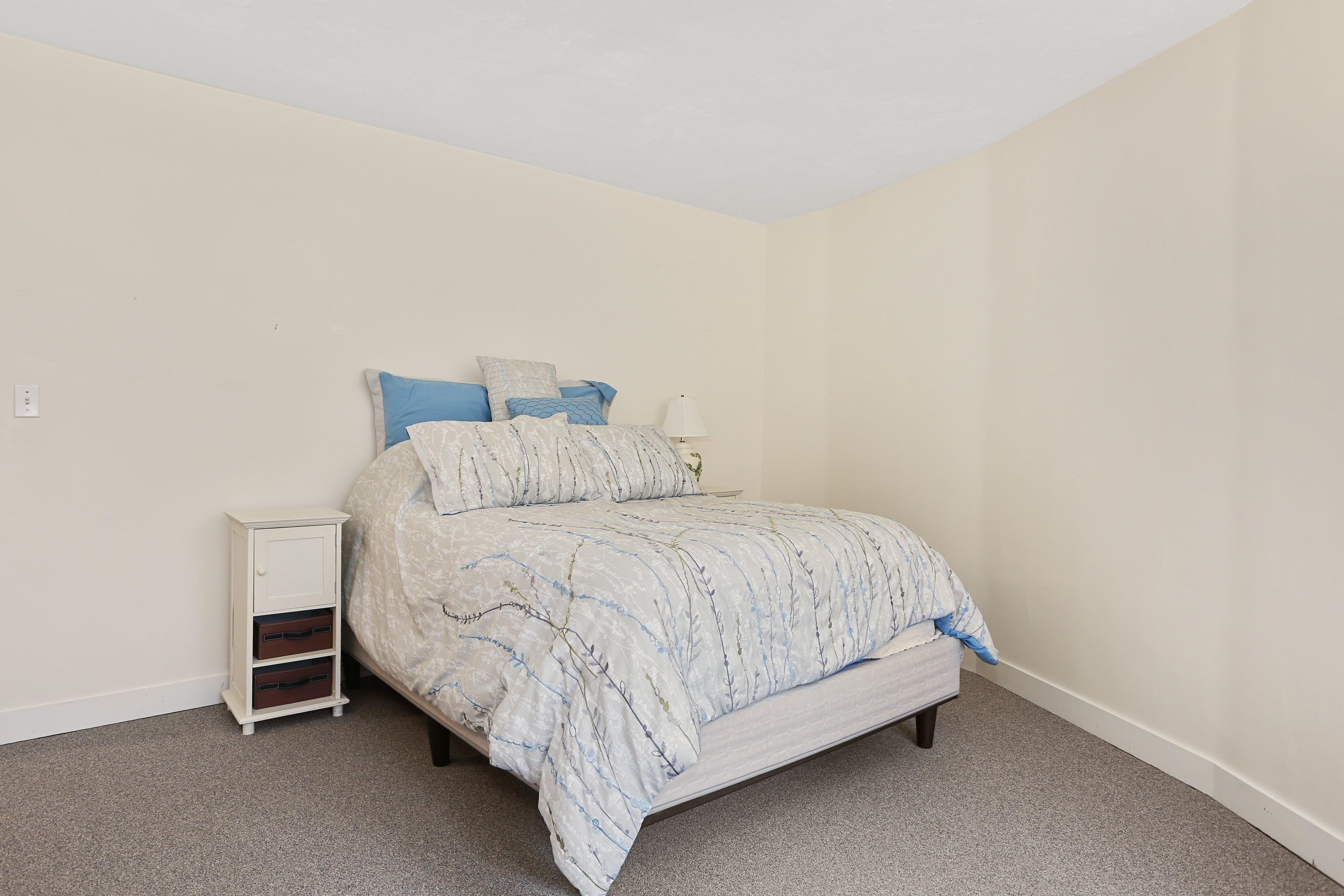 38 Weather Deck Road Bourne, MA 02532 - Photo 10 of 40 a bed sitting in a bedroom next to a window