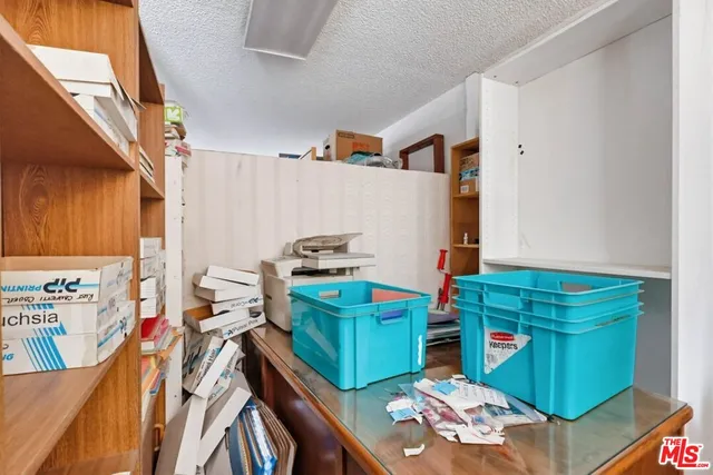 a view of a bedroom with furniture and window