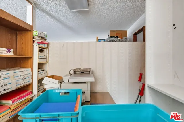 a view of a bedroom with furniture and a window