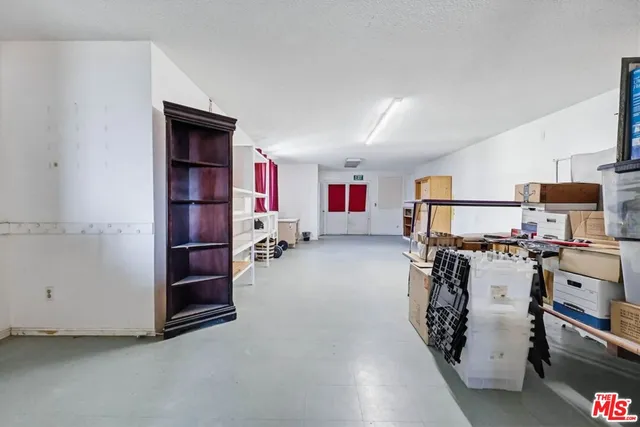 a view of a bedroom with furniture and a bed