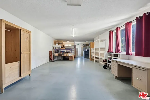 a living room with patio furniture and a flat screen tv