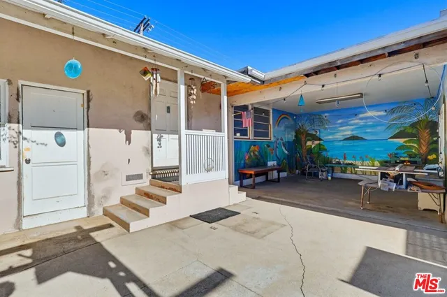 a kitchen with a stove a sink and a window