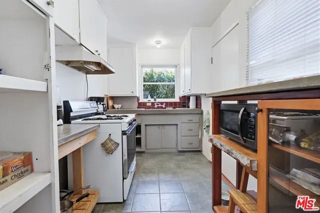 a view of a patio with table and chairs and potted plants