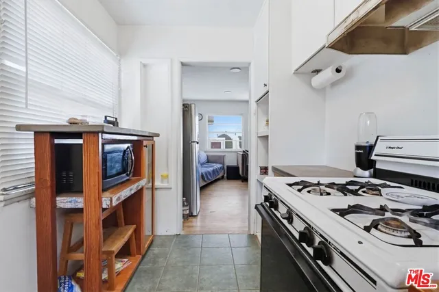 a view of a house with a small yard and wooden fence