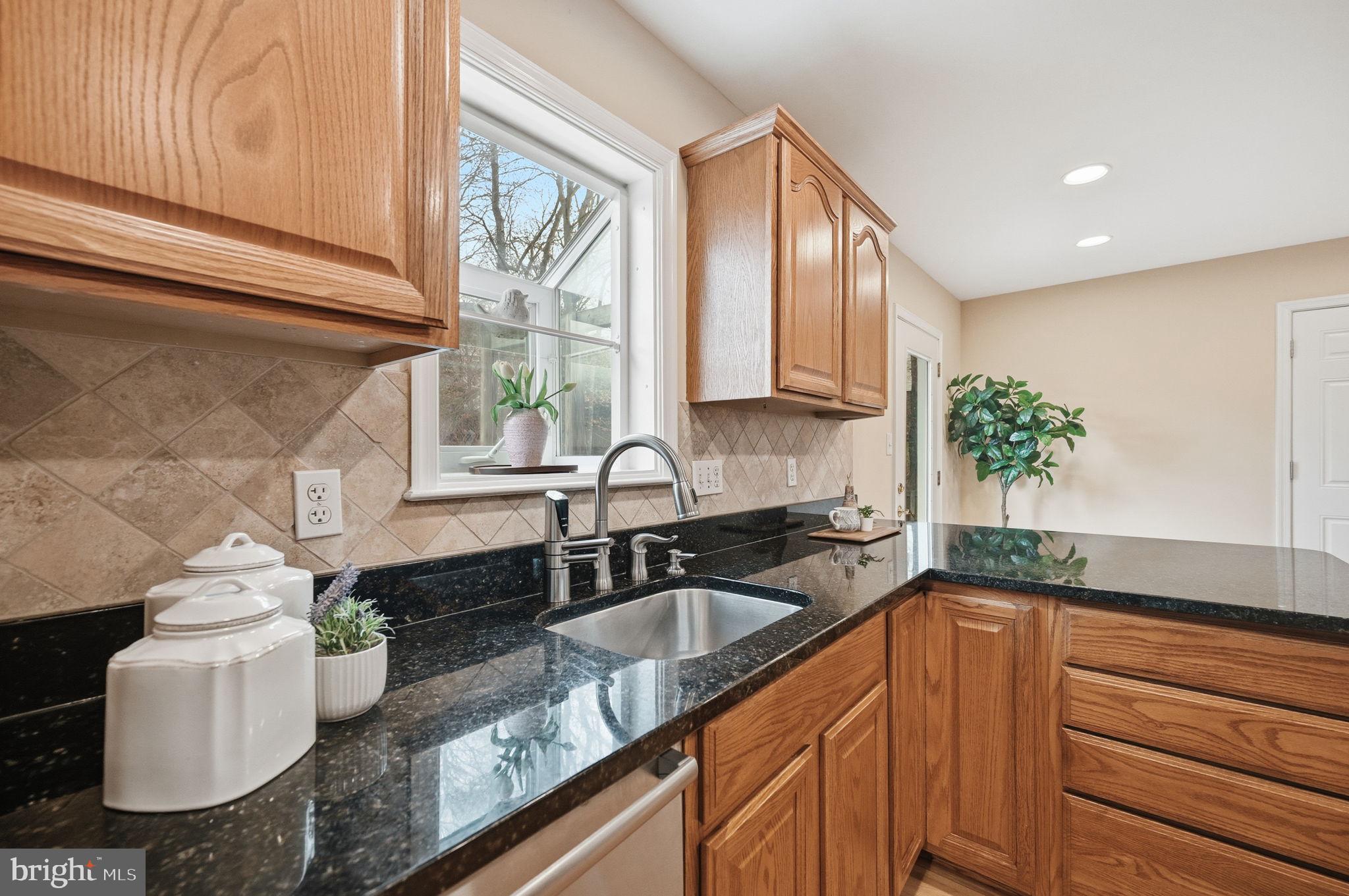 9322 Elk Drive Springfield, VA 22153 - Photo 12 of 43 a kitchen with granite countertop a sink a stove and cabinets
