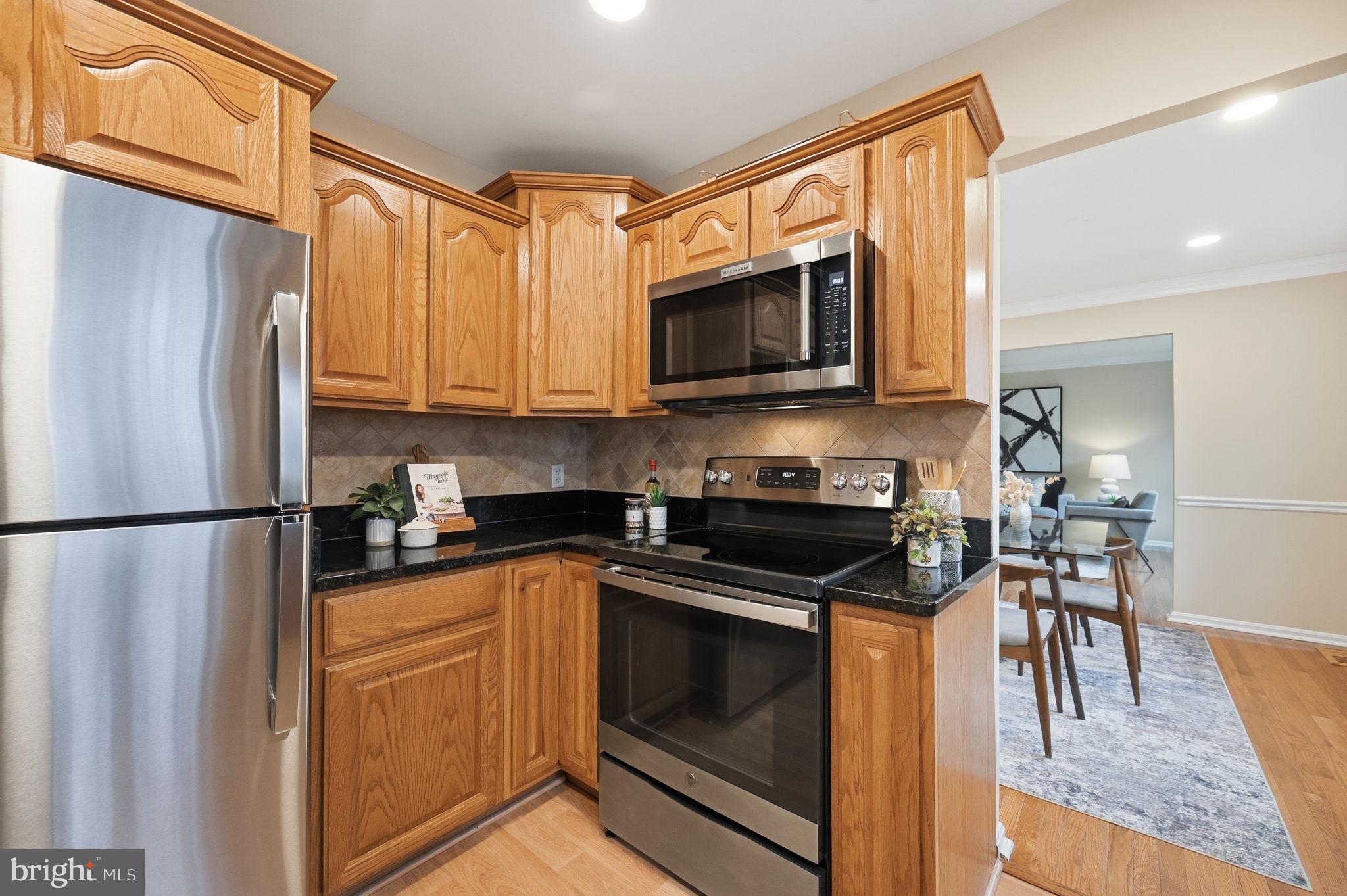 9322 Elk Drive Springfield, VA 22153 - Photo 13 of 43 a kitchen with a refrigerator stove and microwave