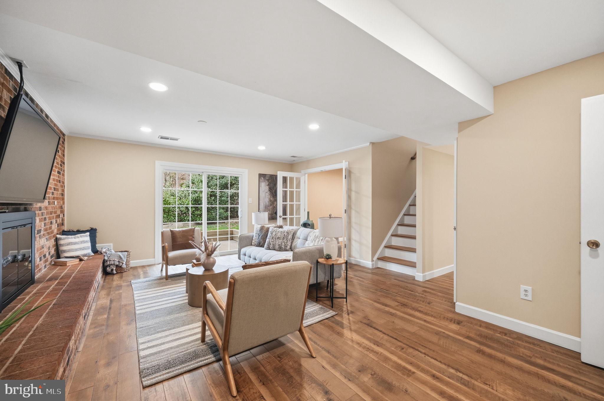 9322 Elk Drive Springfield, VA 22153 - Photo 26 of 43 a living room with furniture a large window and wooden floor