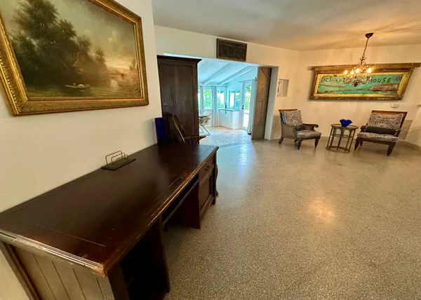 a living room with a table and a large window