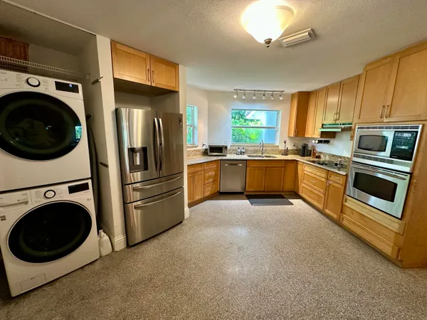 a view of a refrigerator with washer and dryer