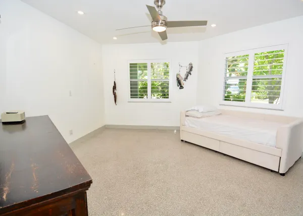 a bed sitting in a bedroom next to a window