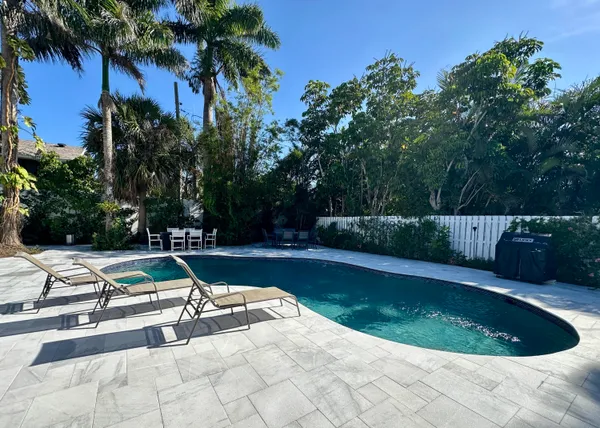 a view of a house with sitting area and garden
