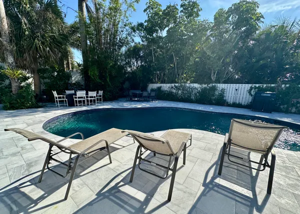 a view of a backyard with table and chairs