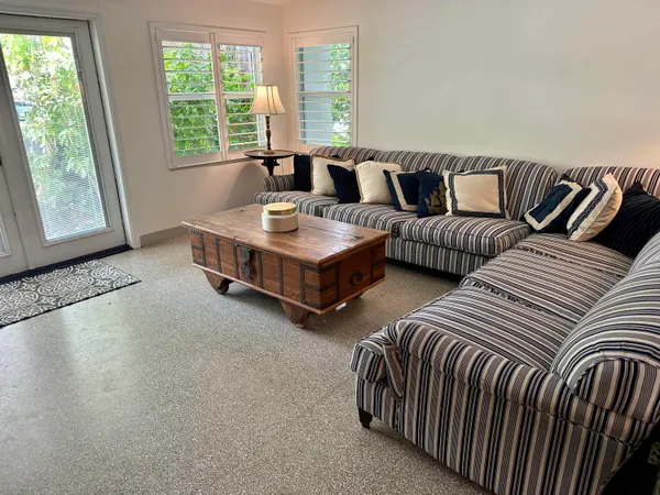 a living room with furniture and large windows