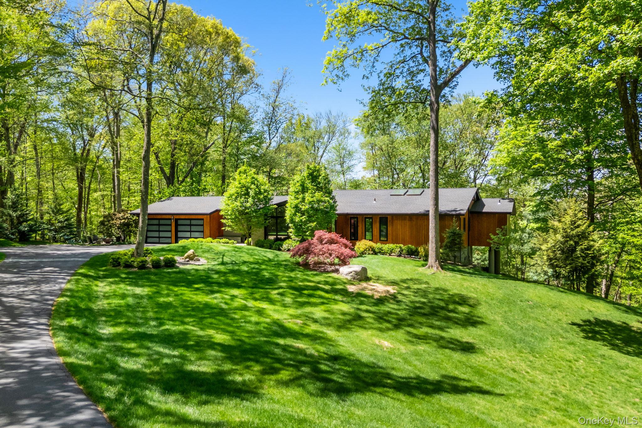 2 Logging Road Waccabuc, NY 10597 - Photo 1 of 46 a front view of a house with a garden
