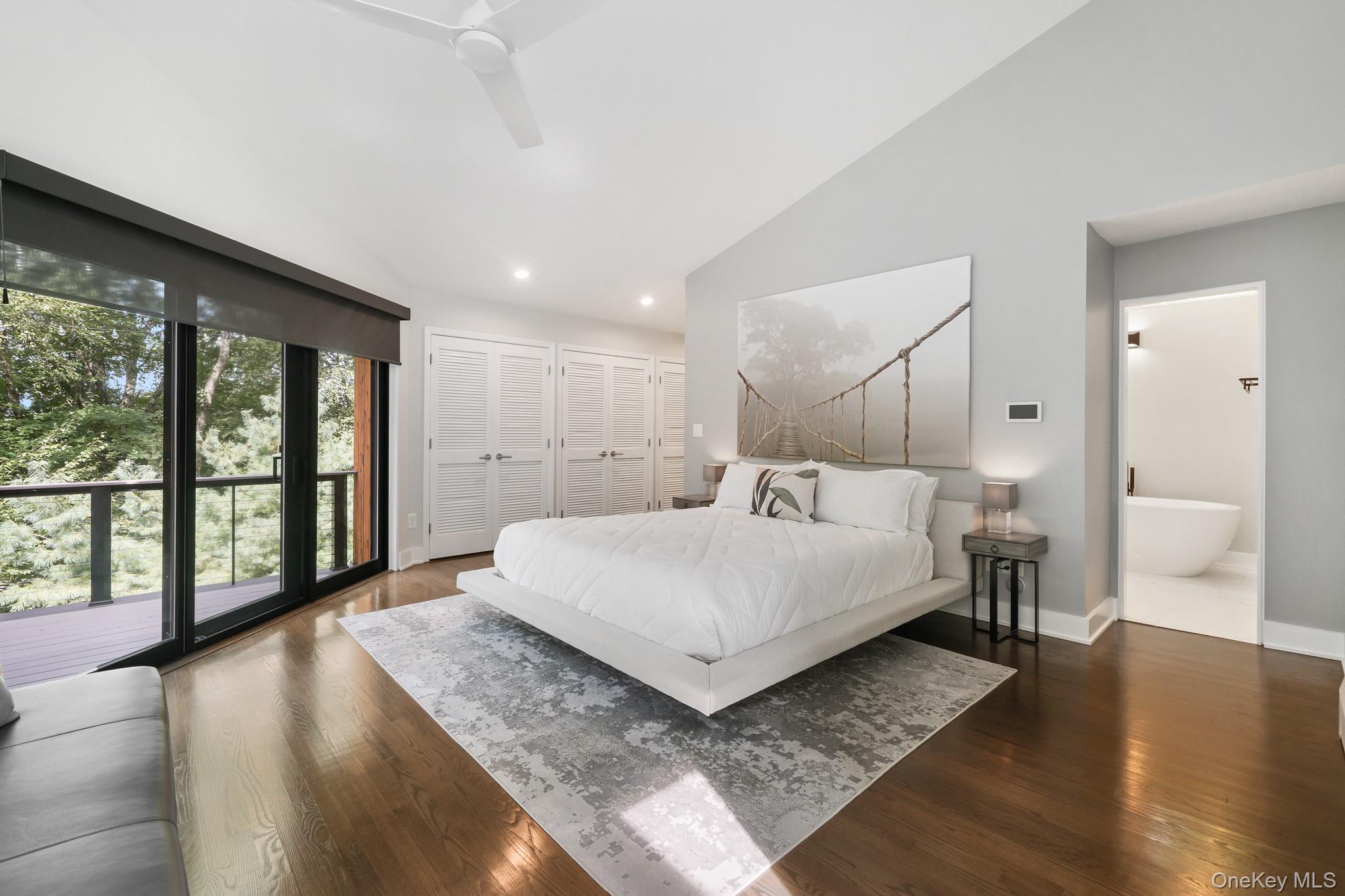 2 Logging Road Waccabuc, NY 10597 - Photo 21 of 46 a spacious bedroom with a large bed and a large window