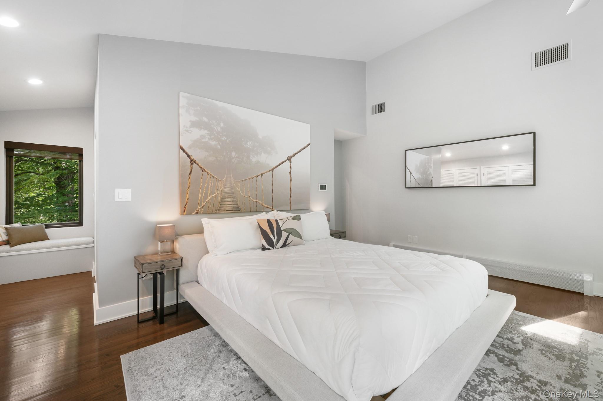 2 Logging Road Waccabuc, NY 10597 - Photo 23 of 46 a bedroom with a large bed and a chandelier