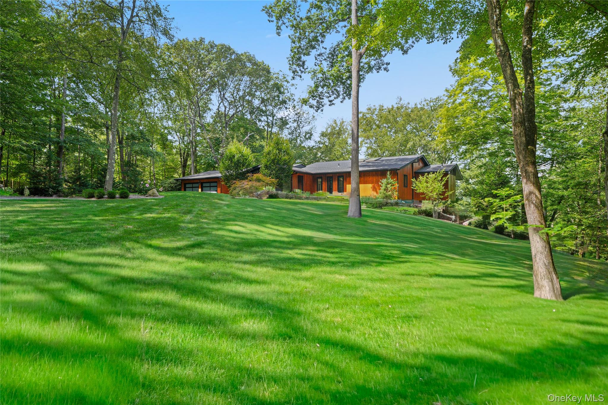 2 Logging Road Waccabuc, NY 10597 - Photo 3 of 46 a backyard of a house with lots of green space and fountain