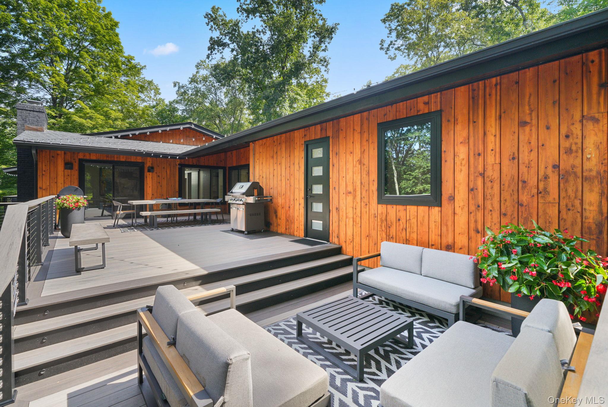 2 Logging Road Waccabuc, NY 10597 - Photo 43 of 46 a view of a patio with couches table and chairs and potted plants