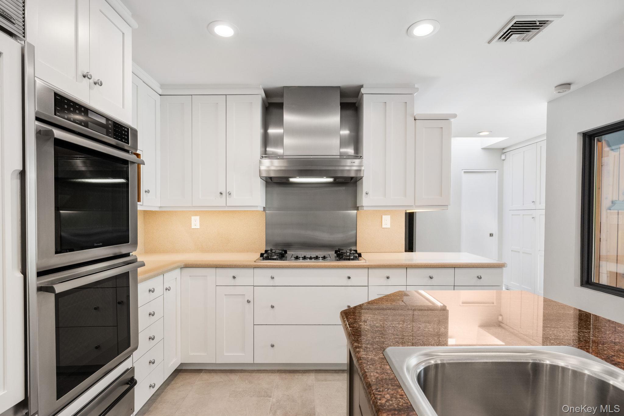 2 Logging Road Waccabuc, NY 10597 - Photo 7 of 46 a kitchen with granite countertop a sink stainless steel appliances and cabinets