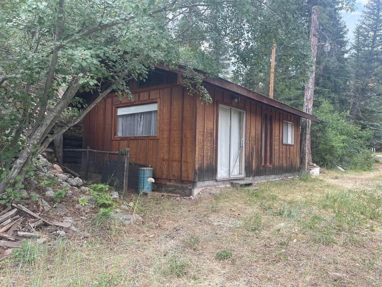 509 Riverside Drive Lyons, CO 80540 - Photo 2 of 15 a backyard of a house with lots of green space