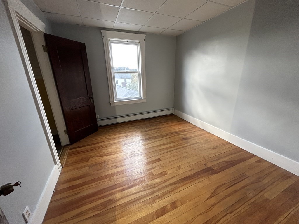 23 Greendale Avenue Worcester, MA 01606 - Photo 20 of 30 an empty room with wooden floor and windows
