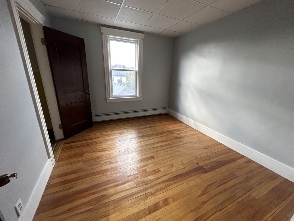 23 Greendale Avenue Worcester, MA 01606 - Photo 21 of 30 an empty room with wooden floor and windows
