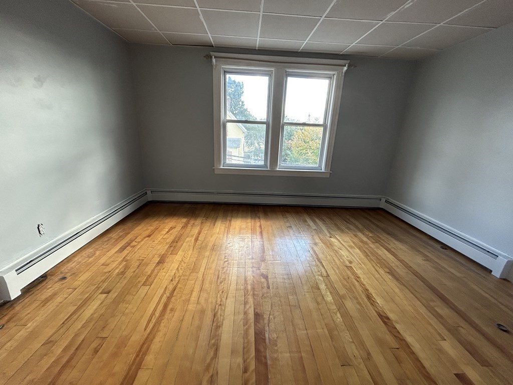 23 Greendale Avenue Worcester, MA 01606 - Photo 23 of 30 an empty room with wooden floor and windows