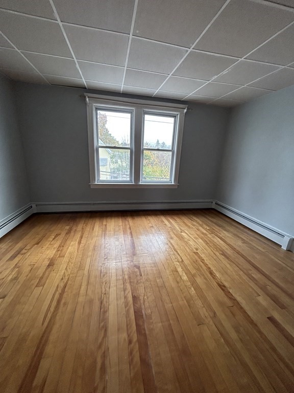 23 Greendale Avenue Worcester, MA 01606 - Photo 26 of 30 an empty room with wooden floor and windows