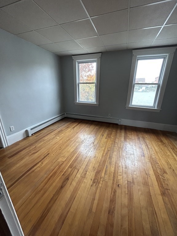 23 Greendale Avenue Worcester, MA 01606 - Photo 27 of 30 an empty room with wooden floor and windows